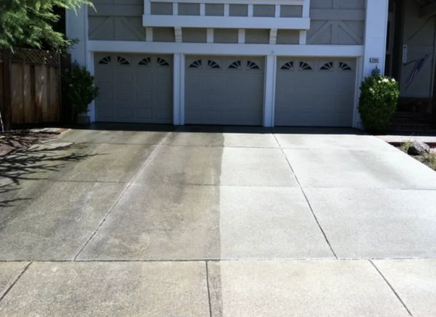 Concrete driveway and garage approach with a visible line between the untreated and treated halves